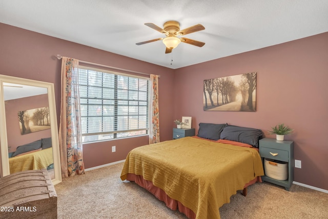 bedroom featuring light colored carpet, ceiling fan, and baseboards