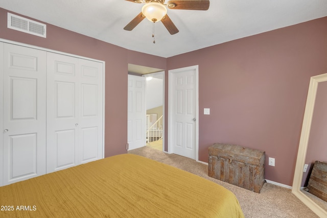 unfurnished bedroom with carpet floors, a closet, visible vents, and a ceiling fan