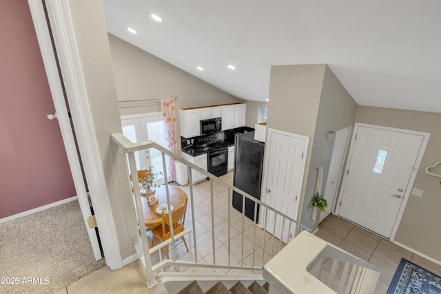 entrance foyer featuring recessed lighting, baseboards, vaulted ceiling, and light tile patterned flooring