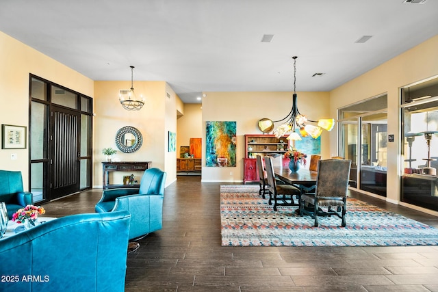 dining space featuring dark wood-type flooring and a chandelier