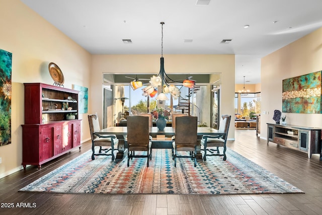 dining space featuring a chandelier and dark hardwood / wood-style floors