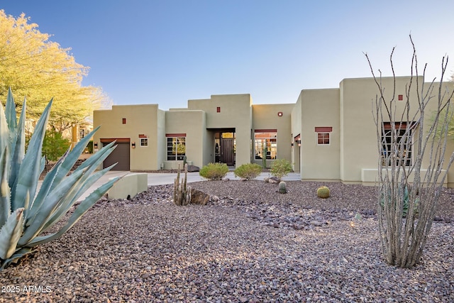 southwest-style home with a garage