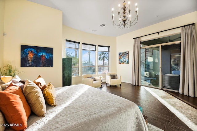 bedroom featuring a notable chandelier, dark wood-type flooring, and access to exterior