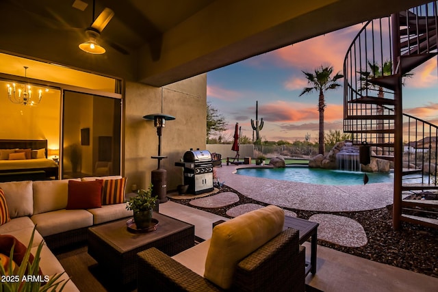 pool at dusk with grilling area, a patio, pool water feature, and outdoor lounge area