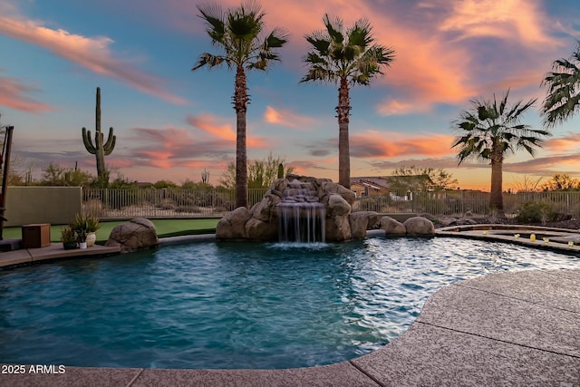 pool at dusk with pool water feature