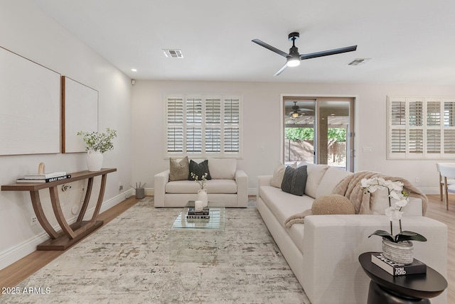 living room with visible vents and wood finished floors