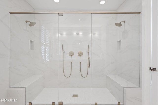 full bath featuring a marble finish shower