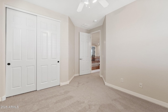 unfurnished bedroom with ceiling fan, carpet floors, visible vents, baseboards, and a closet