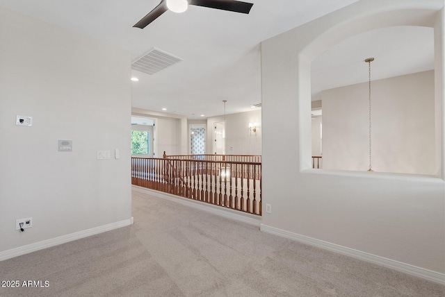 empty room with carpet floors, recessed lighting, visible vents, and baseboards