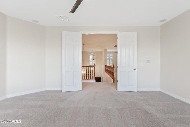 unfurnished room with light carpet, baseboards, and visible vents