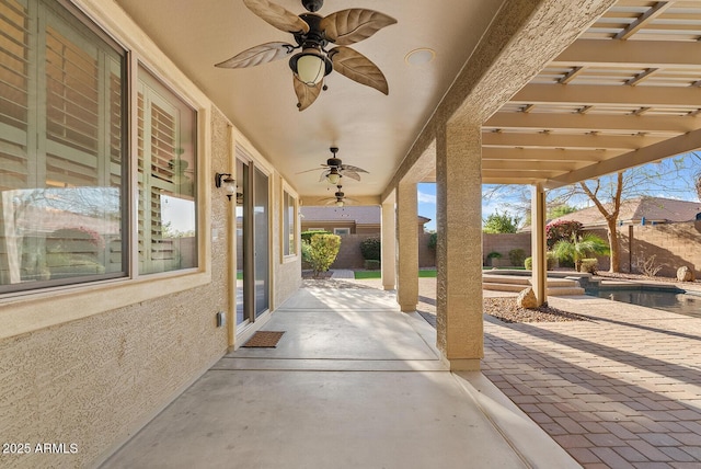 view of patio / terrace featuring a ceiling fan, a pool with connected hot tub, and a fenced backyard