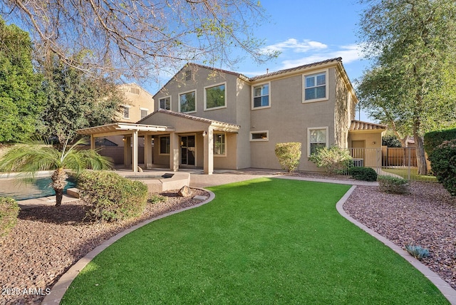 rear view of property with a patio, stucco siding, a lawn, fence, and a pergola