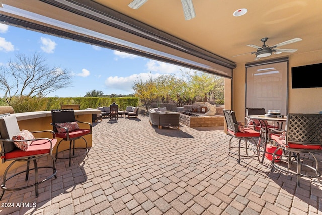 view of patio / terrace with exterior bar, ceiling fan, and outdoor lounge area