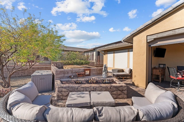 view of patio / terrace featuring an outdoor living space with a fire pit