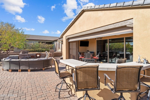 view of patio featuring an outdoor hangout area and a bar