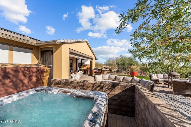 view of patio / terrace featuring outdoor lounge area and a hot tub