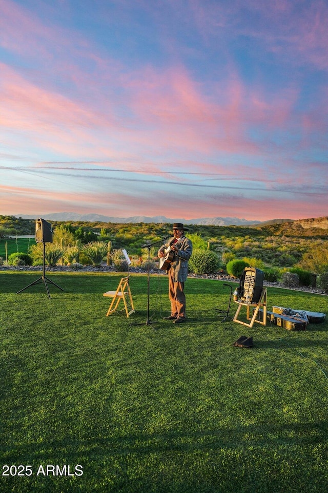 playground at dusk featuring a yard