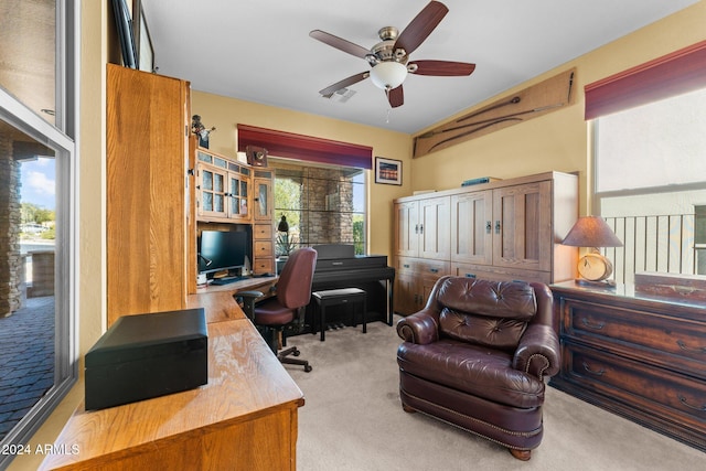 home office featuring light colored carpet and ceiling fan