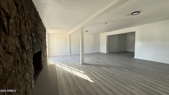 121 E Monte Way, Phoenix, AZ 85042 - unfurnished living room featuring wood finished floors, a fireplace, and baseboards