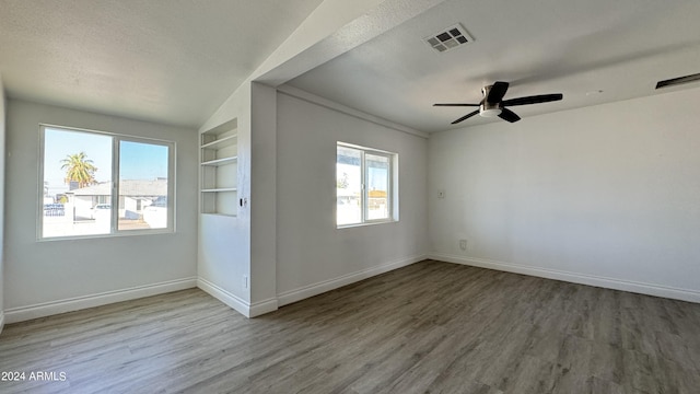 121 E Monte Way, Phoenix, AZ 85042 - unfurnished room with wood finished floors, healthy amount of natural light, baseboards, and ceiling fan