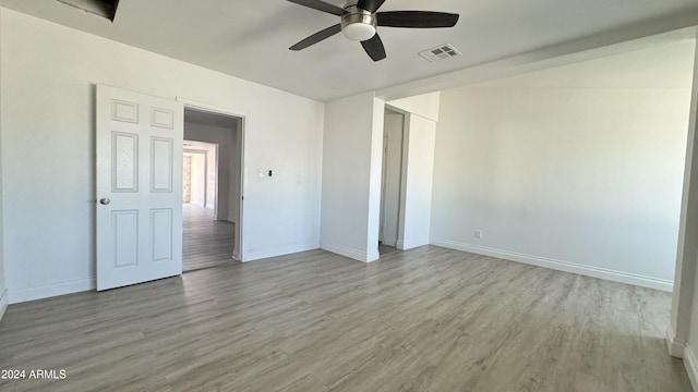 121 E Monte Way, Phoenix, AZ 85042 - unfurnished bedroom with wood finished floors, baseboards, and ceiling fan