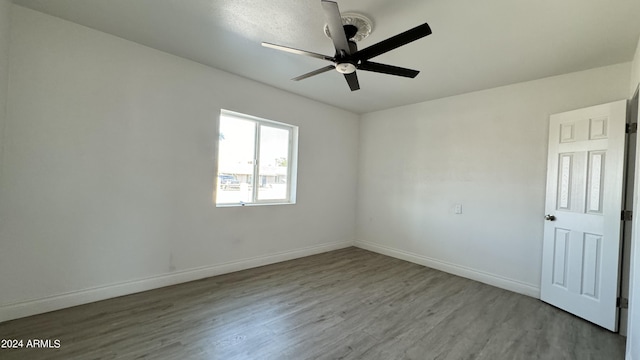 121 E Monte Way, Phoenix, AZ 85042 - empty room with wood finished floors, a ceiling fan, and baseboards