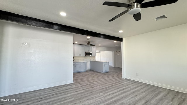 121 E Monte Way, Phoenix, AZ 85042 - unfurnished living room featuring light wood finished floors, ceiling fan, baseboards, and recessed lighting