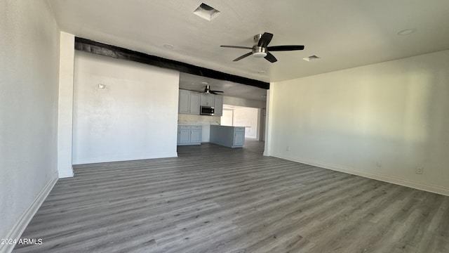 121 E Monte Way, Phoenix, AZ 85042 - unfurnished living room with ceiling fan, wood finished floors, and baseboards