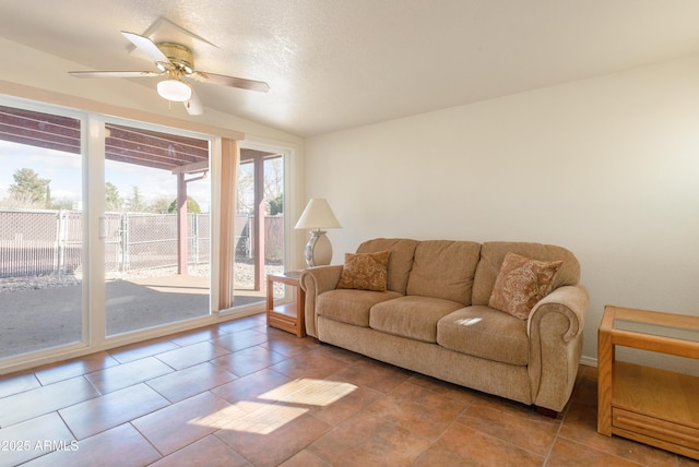 living room with a textured ceiling and a ceiling fan