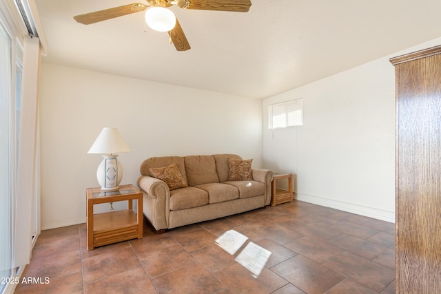 living area featuring ceiling fan and baseboards