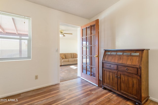 interior space with baseboards and wood finished floors