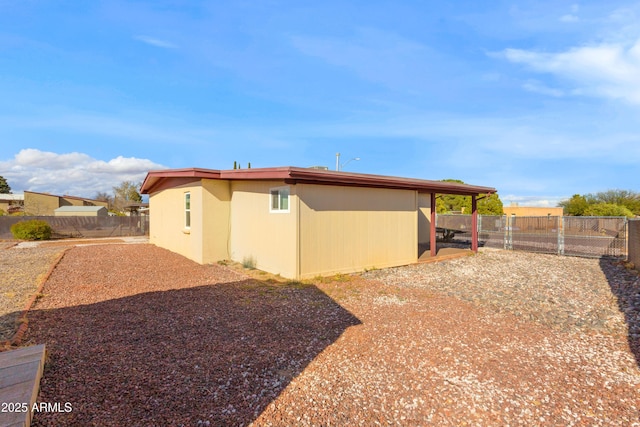 view of side of property with a gate and fence