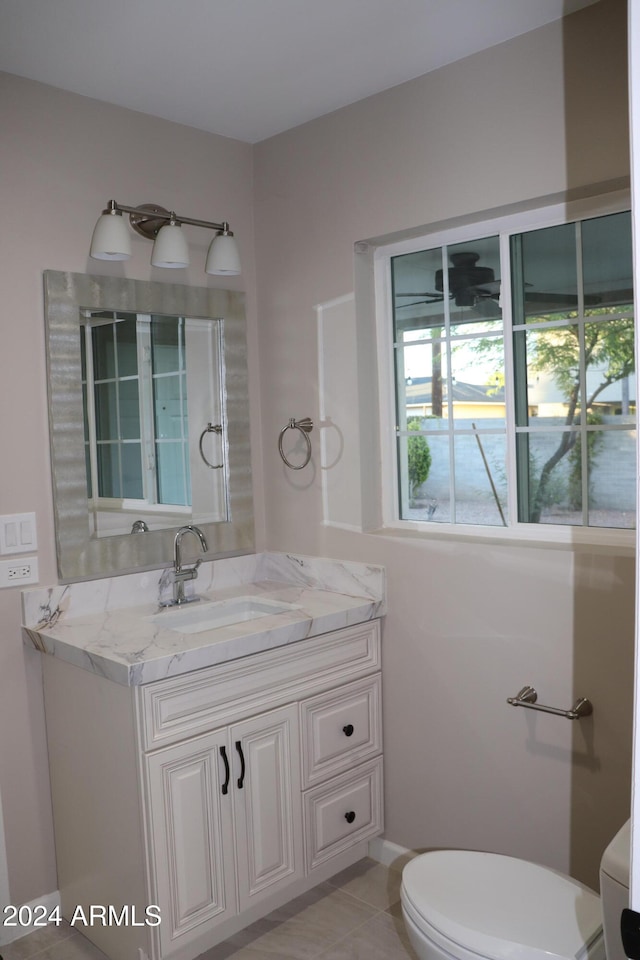 bathroom featuring toilet, vanity, and tile patterned flooring