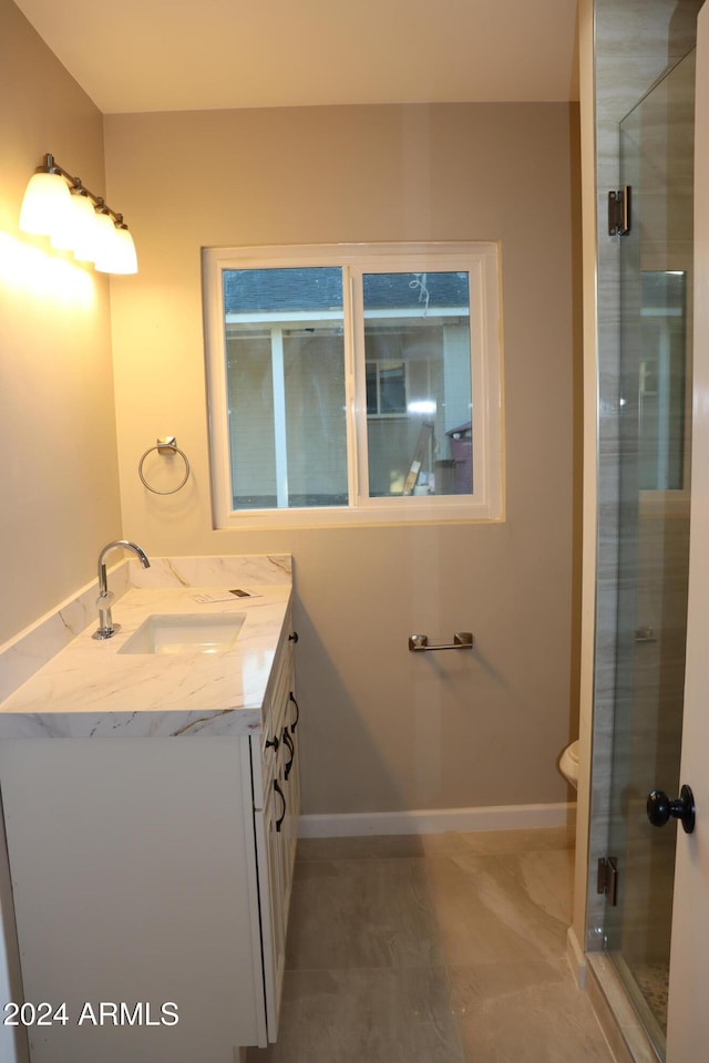 bathroom with an enclosed shower and vanity