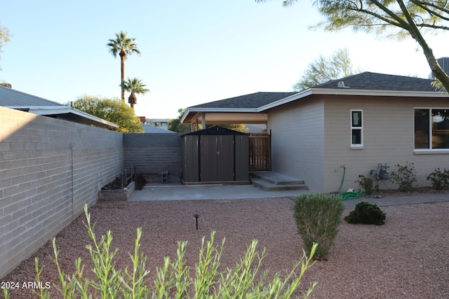 exterior space featuring a storage unit and a patio area