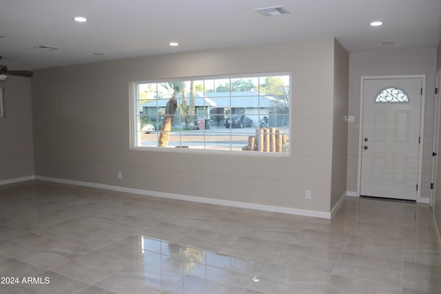 tiled entryway with ceiling fan