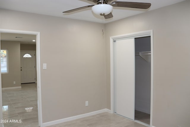 unfurnished bedroom featuring a closet and ceiling fan