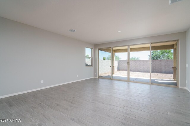 unfurnished room with light wood-type flooring