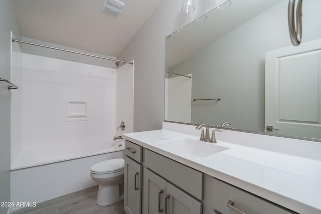 full bathroom featuring shower / bathing tub combination, wood-type flooring, vanity, and toilet