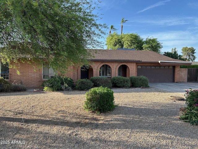 3740 E Mercer Ln, Phoenix, AZ 85028 - ranch-style house with brick siding, a garage, driveway, and roof with shingles
