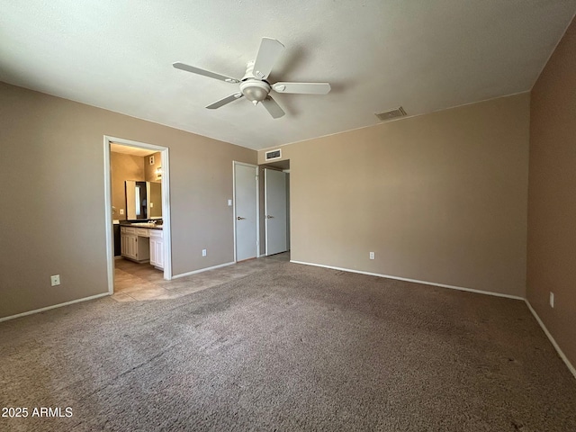 3740 E Mercer Ln, Phoenix, AZ 85028 - unfurnished bedroom with light colored carpet, ensuite bath, and ceiling fan