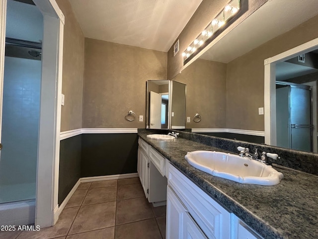 3740 E Mercer Ln, Phoenix, AZ 85028 - full bath with double vanity, a shower stall, and tile patterned floors