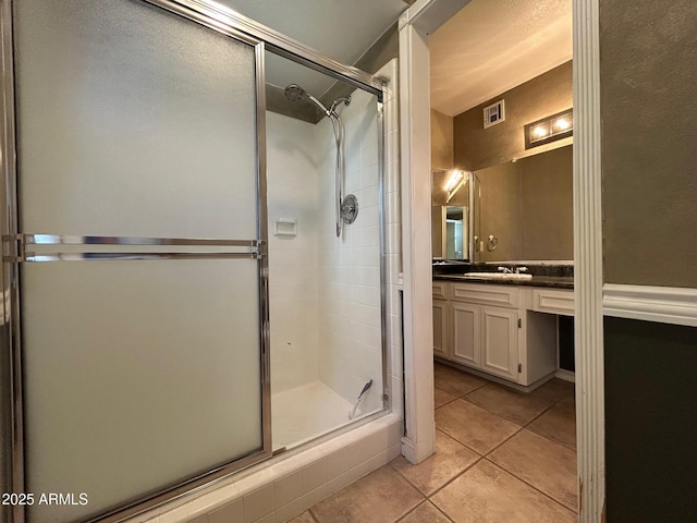3740 E Mercer Ln, Phoenix, AZ 85028 - bathroom with tile patterned floors, a shower stall, and vanity