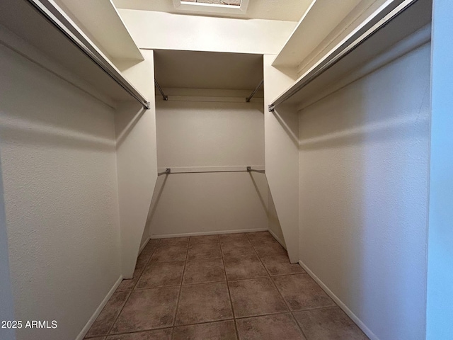 3740 E Mercer Ln, Phoenix, AZ 85028 - walk in closet with dark tile patterned floors