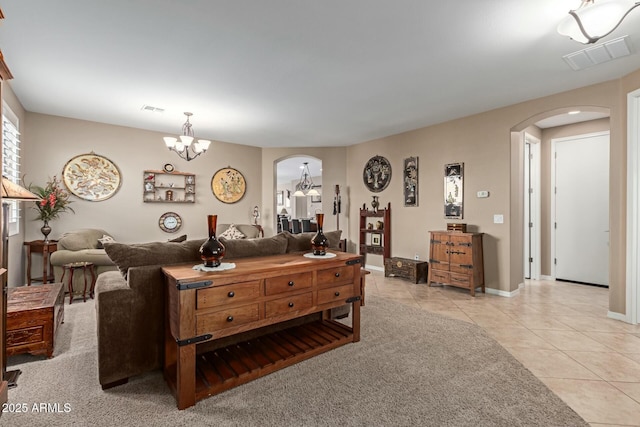 tiled living room featuring a notable chandelier