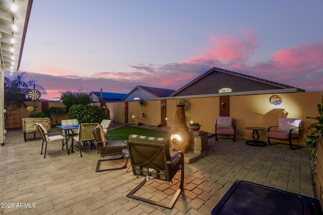 view of patio terrace at dusk