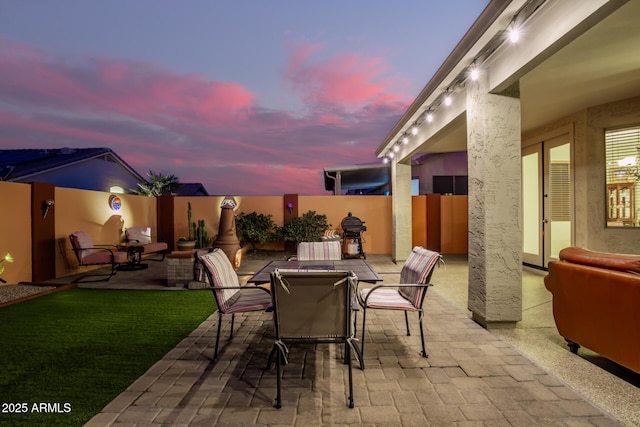 view of patio terrace at dusk