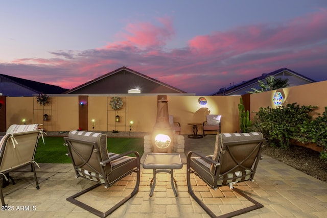 view of patio terrace at dusk