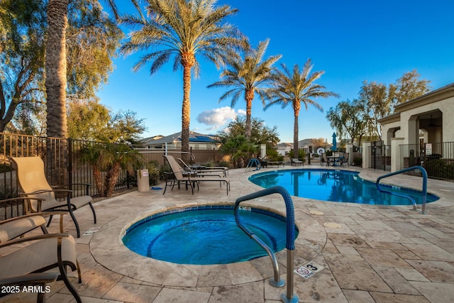 view of swimming pool with a patio area and a hot tub