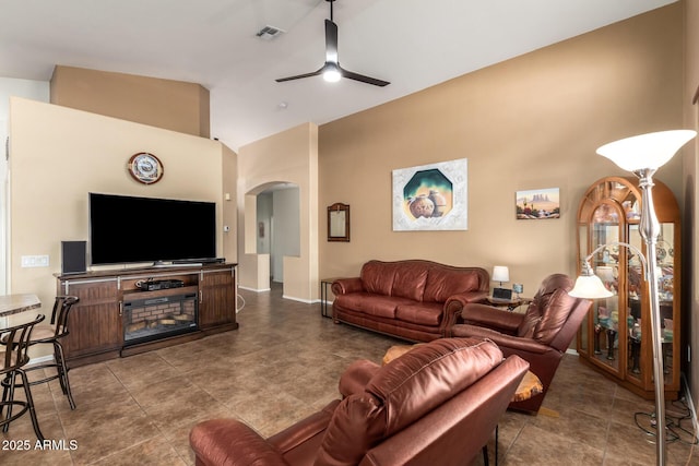 living room featuring ceiling fan and high vaulted ceiling